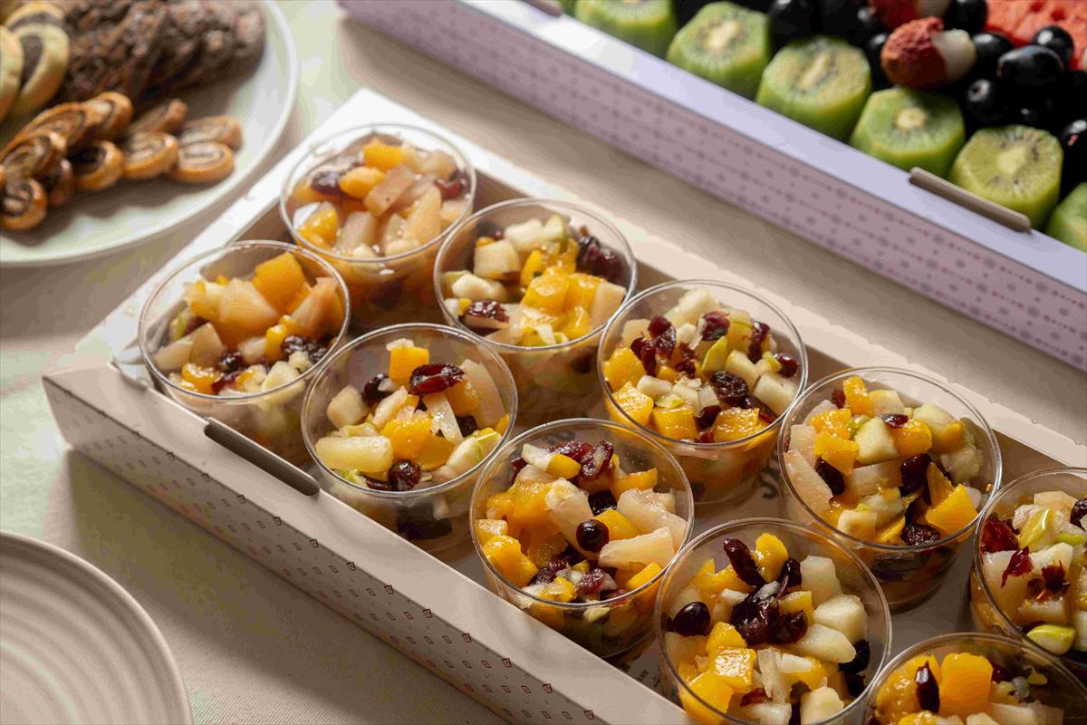 A tray of fruits & pecans salad cups