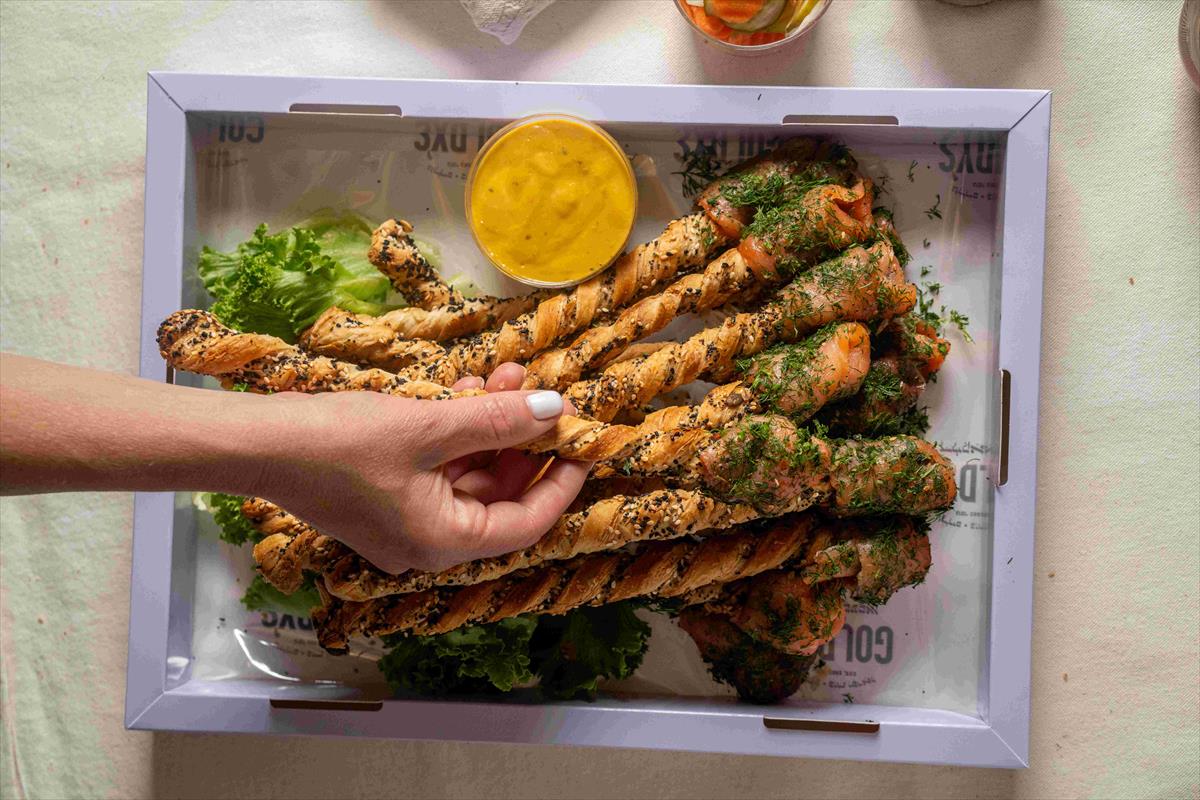 A tray of smoked salmon grissini sticks with Dijon dressing