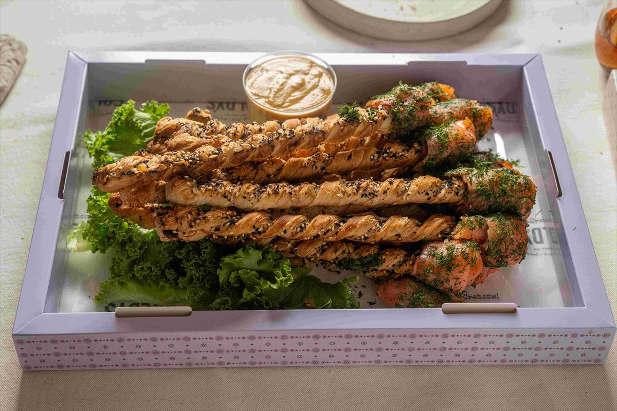A tray of smoked salmon grissini sticks with Dijon dressing