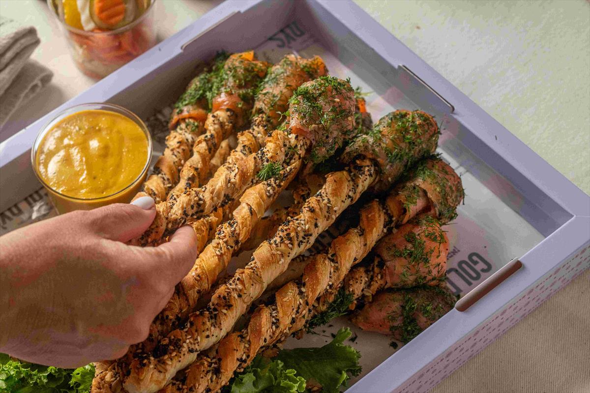 A tray of smoked salmon grissini sticks with Dijon dressing